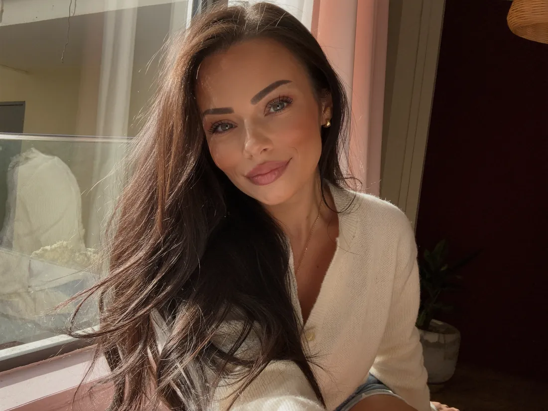 Ani Shanti smiling by the window